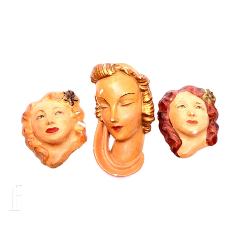 474 - Three Art Deco plaster wall masks, including half portrait of a lady, with golden curls and peach he... 