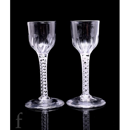 753 - A pair of 18th Century drinking glasses circa 1765, each with as basal fluted ogee bowl above an opa... 
