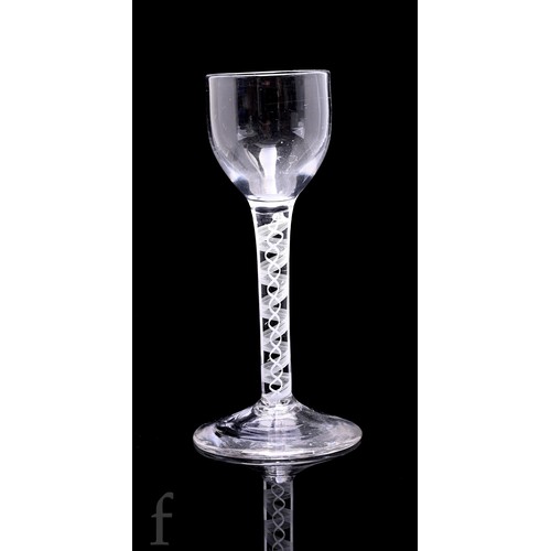 754 - An 18th Century drinking glass circa 1765, the ovoid bowl above a double series opaque twist stem fo... 