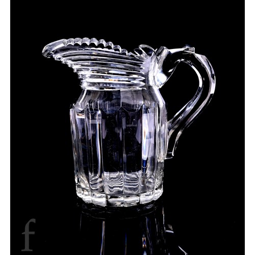 711 - An early 19th Century cut glass water jug possibly Irish, incised dentil cut rim, prism cut neck, an... 