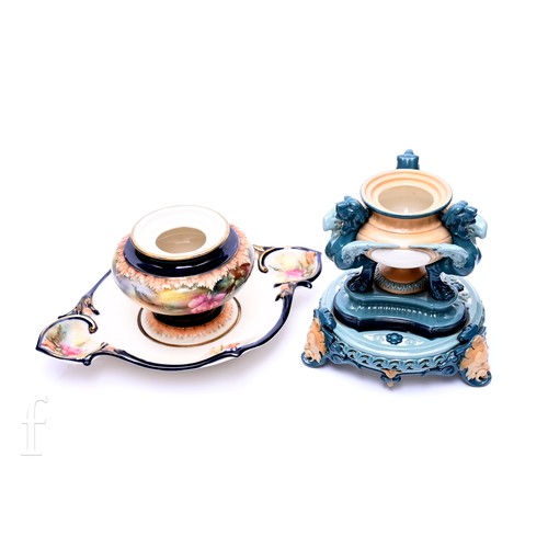 483 - A Hadley's Worcester inkwell, in the form of a pedestal urn supported by three Griffins on moulded t... 