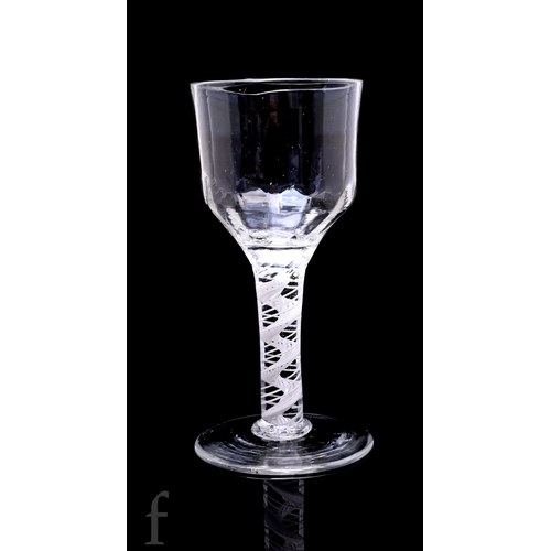 725 - An 18th Century goblet circa 1760, the large ogee bowl with basal molding above a heavy double serie... 