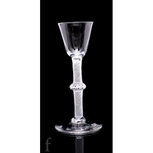 731 - An 18th Century cordial drinking glass circa 1765, the small round funnel bowl above an opaque twist... 