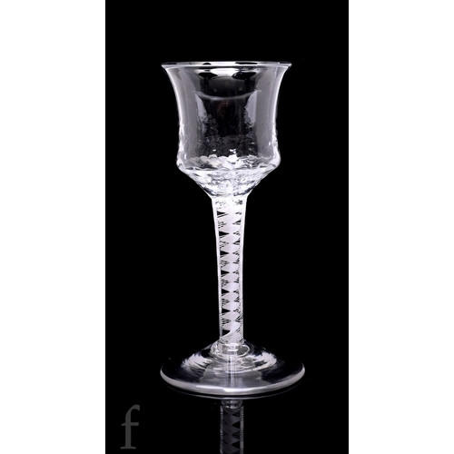 732 - An 18th Century drinking glass circa 1765, the waisted ogee bowl with everted rim and hammered finis... 