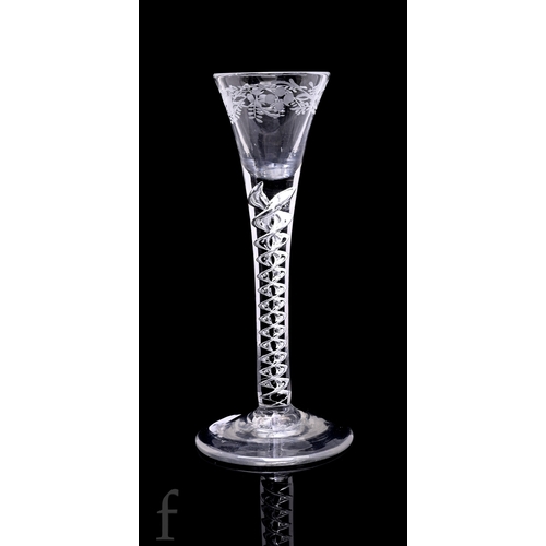 733 - An 18th Century cordial drinking glass circa 1750, drawn funnel bowl engraved to the rim with flower... 