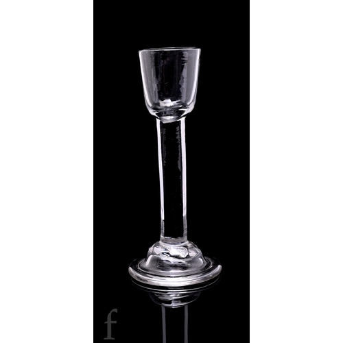 734 - An Irish style 18th Century cordial drinking glass circa 1740, of dark metal the small round funnel ... 