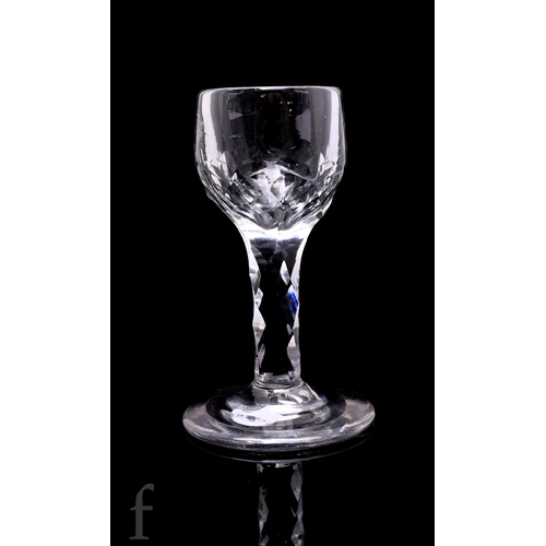 735 - An 18th Century drinking glass circa 1770, the deceptive round funnel bowl with flat cut decoration ... 