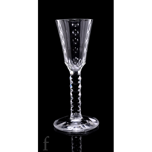 737 - An 18th Century drinking glass circa 1770, the tall round funnel bowl slice cut with vertical bands ... 