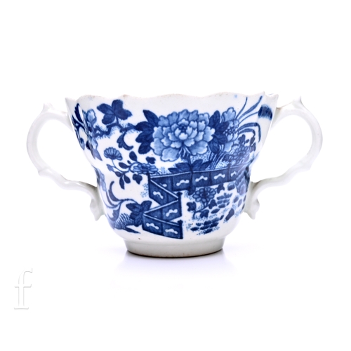 A Worcester Fence pattern chocolate cup, of twin handled fluted form with shaped rim, underglaze blue printed Zig-zag fence with flowering branches and island landscape with flying birds to reverse, filled crescent mark, height 7.5cm.