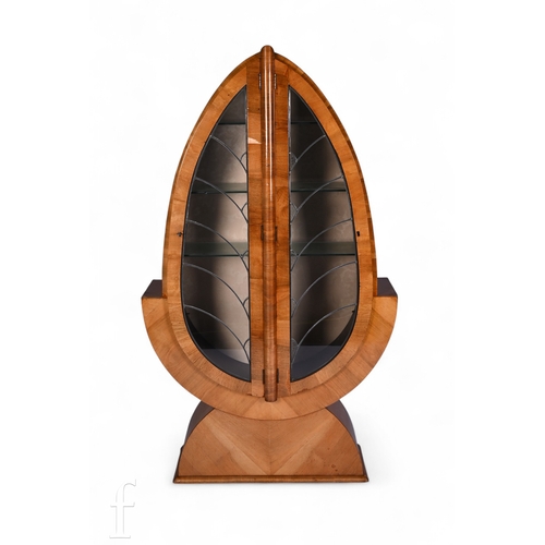 738 - Unattributed Maker - An Art Deco walnut veneered display cabinet of stylised spearhead form, with le... 