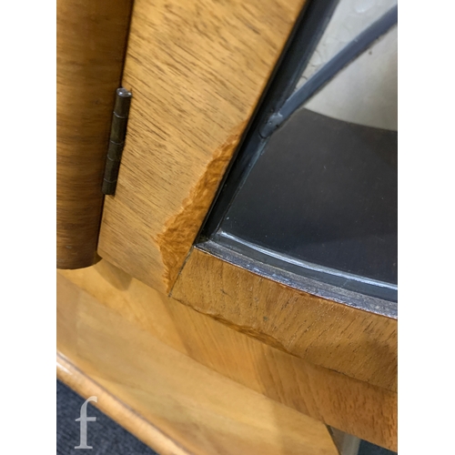 738 - Unattributed Maker - An Art Deco walnut veneered display cabinet of stylised spearhead form, with le... 