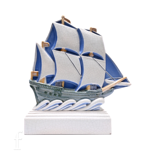 Harold Stabler - Carter Stabler & Adams - An Art Deco Poole Pottery flat back galleon, modelled in full sail with lapping stylised waves on stepped rectangular plinth base, impressed marks to reverse, height 28cm.