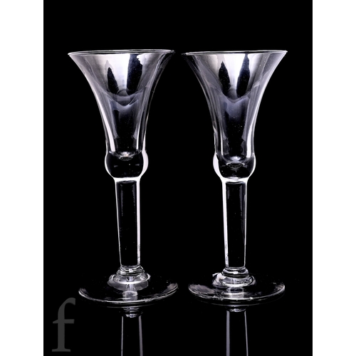 121 - A pair of late 19th to early 20th Century drinking glasses in the 18th Century taste, the large draw... 