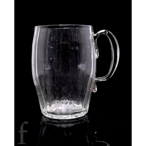 146 - A late 18th Century glass tankard, the swollen barrel form body with vertical fluted and an applied ... 