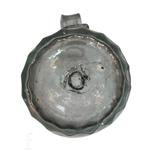 146 - A late 18th Century glass tankard, the swollen barrel form body with vertical fluted and an applied ... 