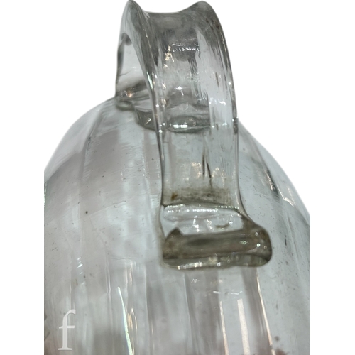 146 - A late 18th Century glass tankard, the swollen barrel form body with vertical fluted and an applied ... 