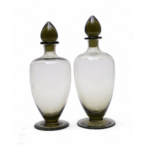 160 - A pair of 1930s Scandinavian Art Deco glass decanters of footed, shouldered ovoid form with tear dro... 