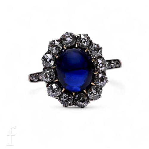 577 - A late Victorian sapphire and diamond ring, circa 1890, the cabochon-cut sapphire, claw set within a... 