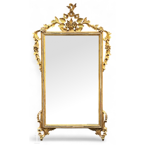 1262 - A reproduction wall mirror with a swagged floral garland gilt frame, height 114cm and width 64cm.