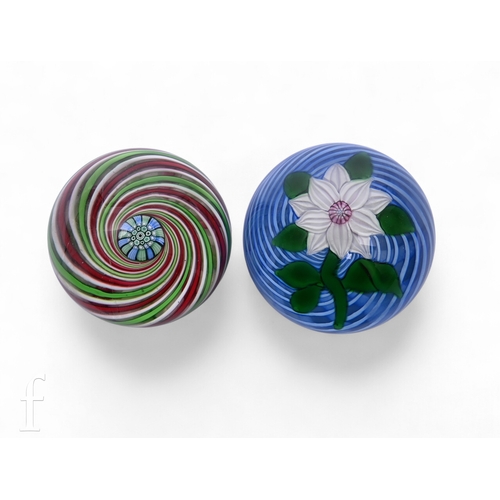551 - A later 20th Century John Deacons glass paperweight, of domed form internally decorated with a large... 