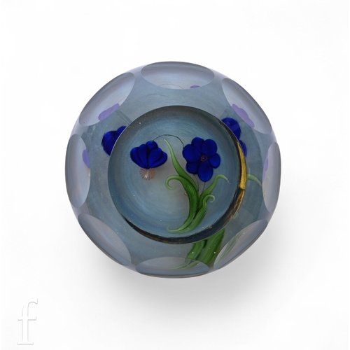 568 - A 20th Century Lundberg Studios large glass paperweight, internally decorated with two stylised lamp... 