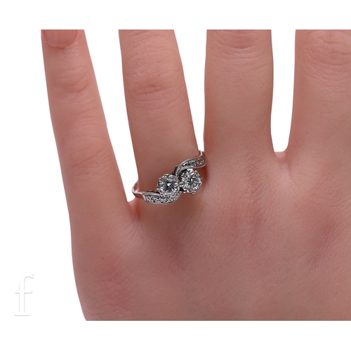 7 - A two stone diamond ring, circa 1951, the brilliant-cut diamonds in fluted collet mounts, above diam... 
