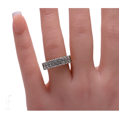 9 - A half hoop diamond eternity ring, set with two rows of nine eight-cut diamonds, mounted in white go... 
