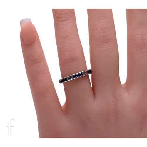 10 - An Edwardian sapphire and diamond eternity ring, set with square-cut diamonds and square-cut sapphir... 