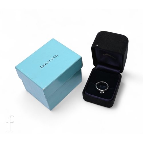 45 - Tiffany & Co; A single stone diamond ring, the brilliant-cut diamond collet set on a broad plati... 