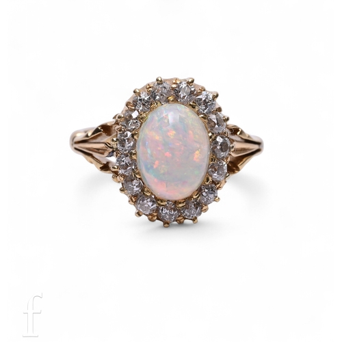 14 - An opal and diamond ring, the oval cabochon-cut opal within a border of old brilliant-cut diamonds, ... 