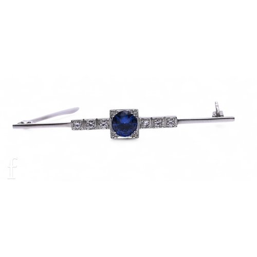 17 - A sapphire and diamond brooch, the circular mixed-cut sapphire claw set within a square mount with m... 