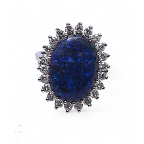 19 - A black opal and diamond ring, the oval cabochon opal within a diamond set bezel, low basket set on ... 