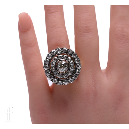 1 - A diamond cluster ring, the upper section circa 1860, of target design composed of an old brilliant-... 