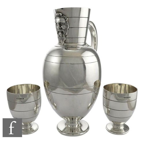 1774 - A Victorian hallmarked silver water jug and two matching goblets, Martin Hall & Co, London 1873 ... 