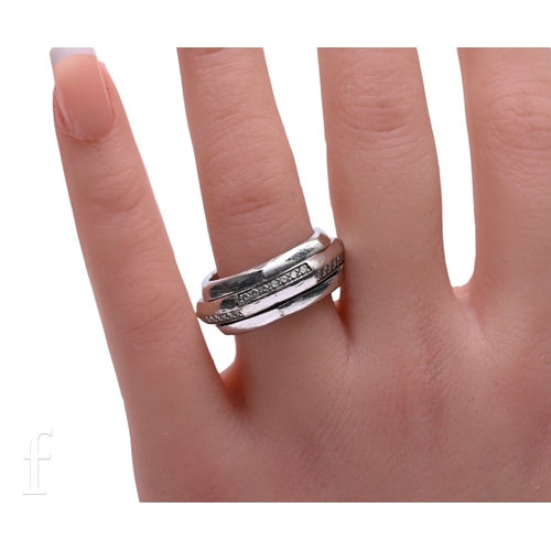 24 - Piaget; A diamond and white gold ring, of hexagonal shape, the central swivel section set throughout... 