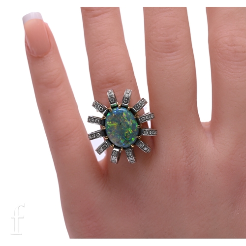 43 - An opal and diamond ring, the oval black opal, claw set within a fancy mount, of twelve arched mount... 