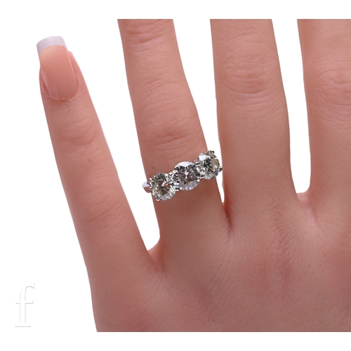 48 - A three stone diamond ring, the three brilliant-cut diamonds four claw set within platinum mount, to... 