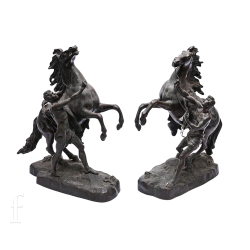 499 - After Cousteau - A pair of late 19th Century bronze Marley horses with attendants each holding a rei... 