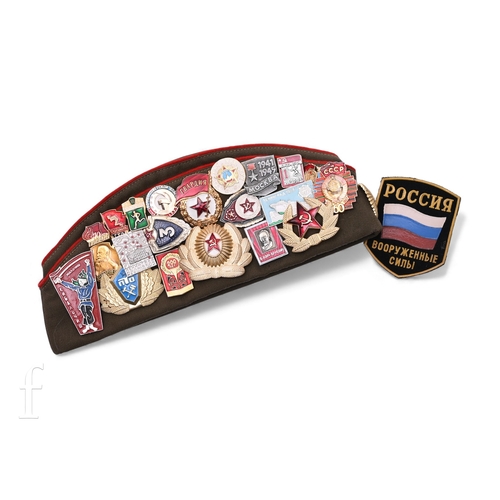 651 - A Russian khaki cloth hat pinned with various enamel badges circa 1960s and 1970s.