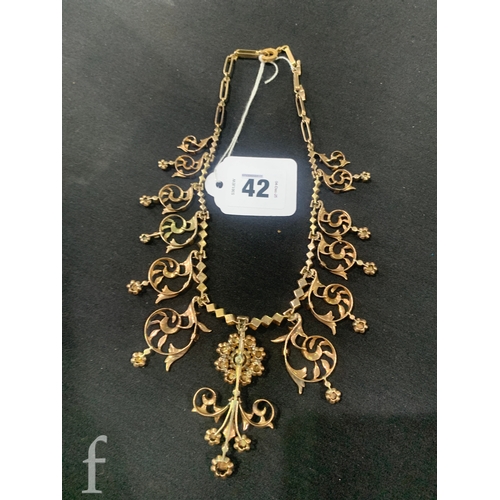 42 - A diamond necklace, the front with a rose cut diamond cluster, suspending an articulated scroll drop... 