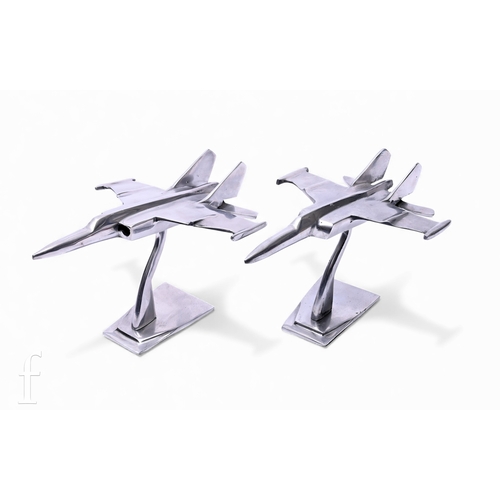 553 - A pair of chromed display stands modelled as a pair of fighter jets, on wedge shaped stands, length ... 