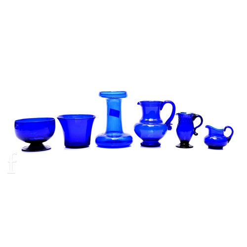 234 - A quantity of early 19th Century and later Bristol Blue glass wares, comprising an ovoid bodied jug ... 