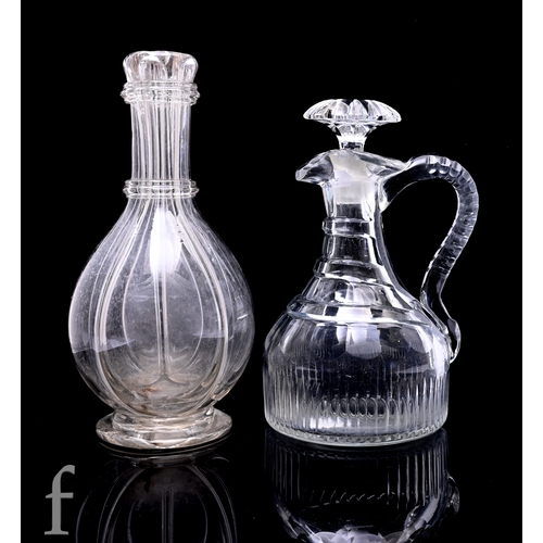 267 - A later Georgian clear crystal claret jug, the compressed ovoid body with flute cut basal collar bel... 