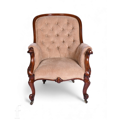 785 - A Victorian mahogany scroll arm easy chair on floral carved cabriole legs to the front, upholstered ... 