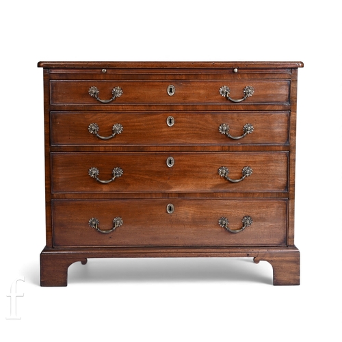 788 - A George III mahogany bachelors chest of four long drawers, below a brushing slide and rounded mould... 