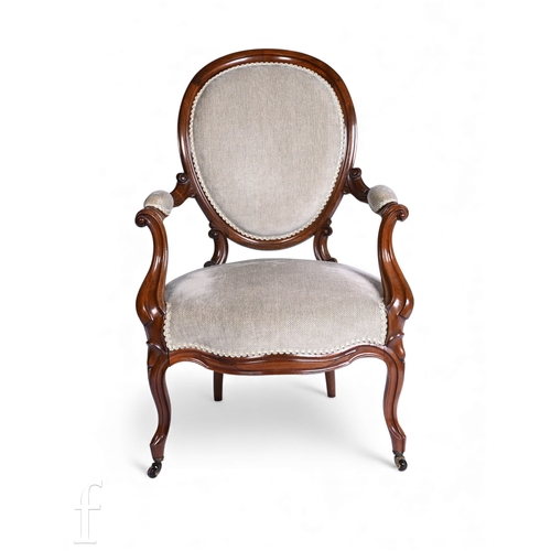 784 - A Victorian open scroll arm easy chair on cabriole legs, upholstered in pale green fabric.