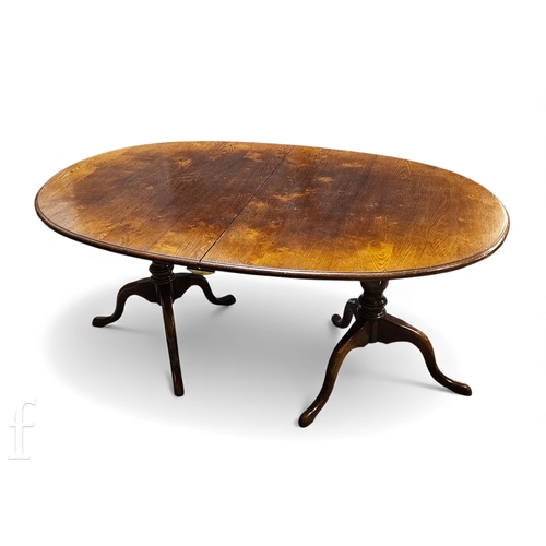 827 - A late 20th Century reproduction oak twin pedestal dining table and eight chairs attributed to Titch... 