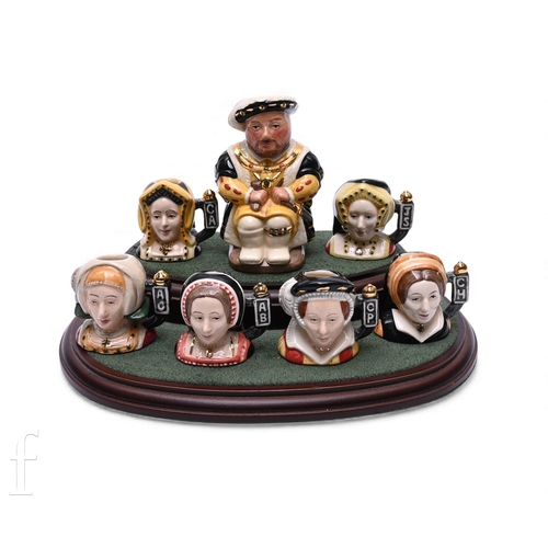 62 - William K Harper for Royal Doulton, a limited edition set of seven miniature toby jugs, modelled as ... 