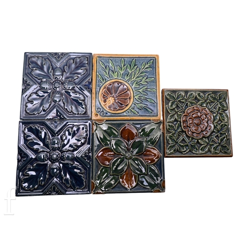 70 - Five Joseph Cliff & Sons (Leeds) plastic clay tiles, each with moulded foliate designs in tonal ... 