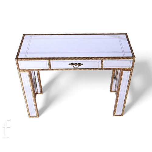 839 - A reproduction mirror panelled consul table with etched detail and with embossed brass border trim, ... 